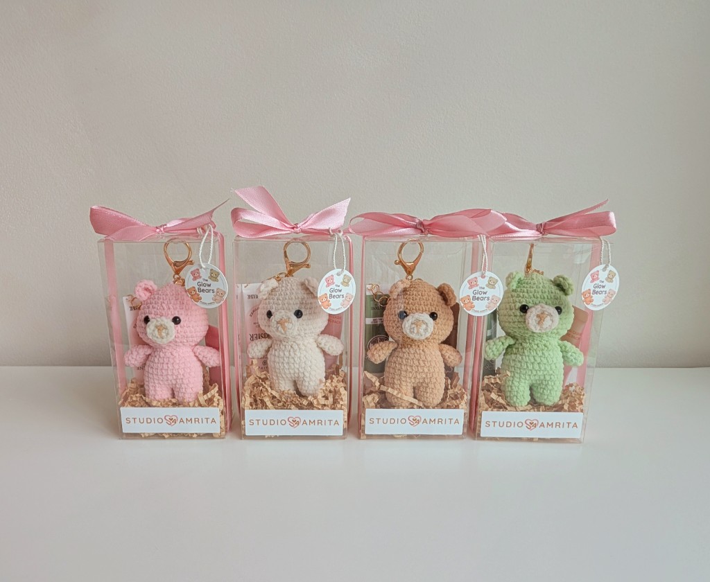 Four Essential Glow Bear gift sets in sakura pink, cloud cream, honey brown, and matcha green